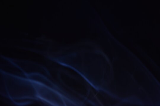 Blue smoke on black background, abstract pattern of smoke 