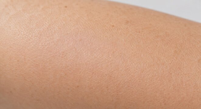 Extreme close up of smooth healthy skin texture on arm after scar treatment
