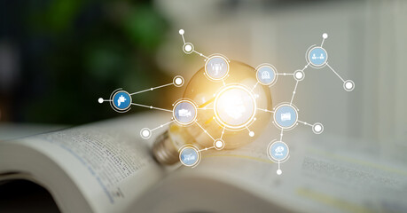 Fototapeta premium An innovative concept illustrating a light bulb illuminating an open book, surrounded by digital icons, symbolizing creativity and the fusion of technology in learning. Tessel