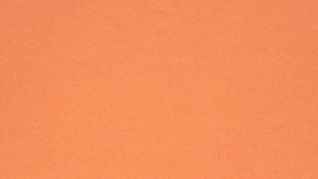 Coral orange textured paper background with subtle grain for minimalist design and copy space