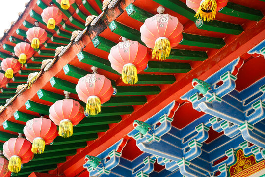 Richly decorated roof edge, red lanterns, and beams of Chinese Thean Hou temple, Kuala Lumpur, Malaysia
