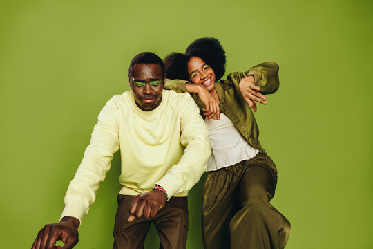 Friends dance together as a playful duo in the studio with modern style
