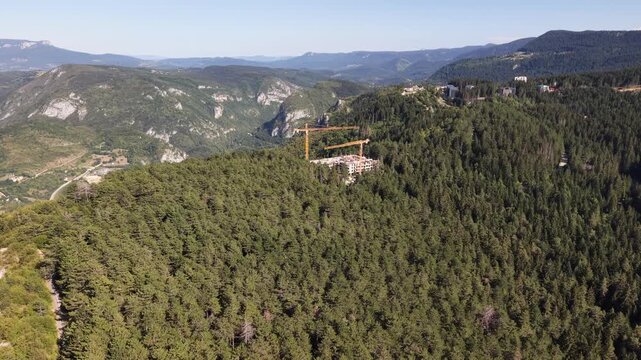 Aerial Flyover of Resort Construction Site with Cranes on Trebevic Mountain