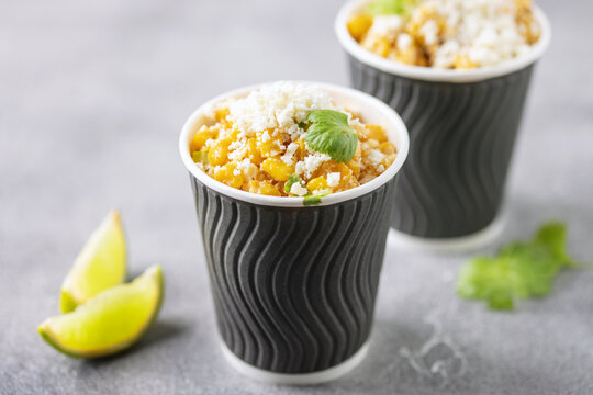 Esquites. Corn kernels cooked and served with mayo,  lime, cheese and chili powder, very popular street food in Mexico