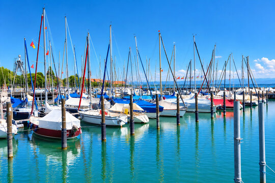 Sailboats in a Sunny Marina with Clear Blue Sky and Calm Water
