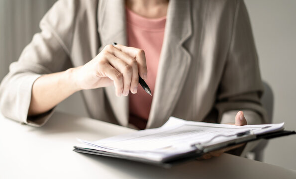 Businesswoman Reviewing Resumes for Recruitment, Hiring Candidates, Analyzing CVs and Applicant Information Before Job Interviews, Human Resources and Recruitment Concept