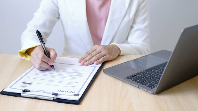 Businesswoman Reviewing Resumes for Recruitment, Hiring Candidates, Analyzing CVs and Applicant Information Before Job Interviews, Human Resources and Recruitment Concept