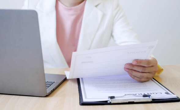 Businesswoman Reviewing Resumes for Recruitment and Hiring Candidates, Analyzing Applicant Information Before Job Interviews in Human Resources and Corporate Office