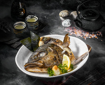 Grilled Kanpachi Fish Head with Lemon and Garnish in Japanese Style