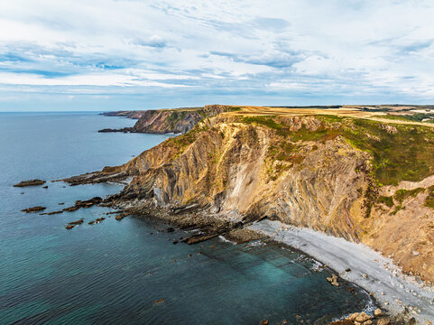 Cliffs and Fields over Welcombe Mouth Beach from a drone, North Devon and Cornwall Coastpath Border, Devon, England, Summer 2026