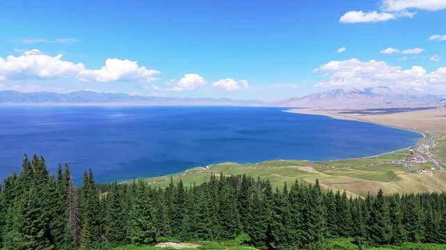 Sailimu Lake in Xinjiang China Summer Aerial View with Blue Water and Pine Forest