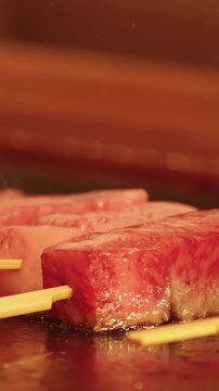Japanese Wagyu Beef Skewers Sizzling on a Teppanyaki Grill