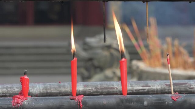 Lit Red Ritual Candles in a Buddhist Temple