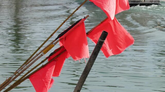 Red Flags Waving on a Tourist Boat in Cassis Harbor