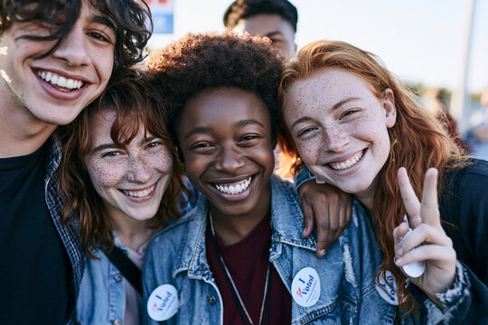 Diverse Young Adults Smiling with I Voted Stickers