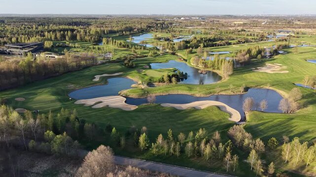Nature filled golf course with lakes and sand traps