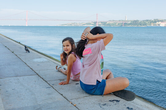 Two Sisters by the Tagus River with 25 de Abril Bridge in Lisbon, Portugal