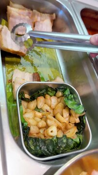 Serving Korean Bossam Pork Belly and Roasted Garlic at Buffet