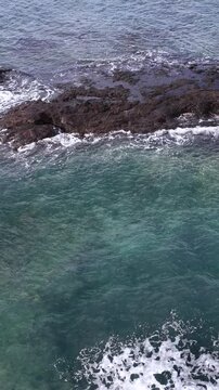 Ocean Waves Crashing Against Dark Rocks on Mornington Peninsula Coastline