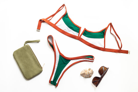 Travel and skincare summer concept &mdash; bikini and cosmetic bag, top view flat lay, beach holiday packing mood