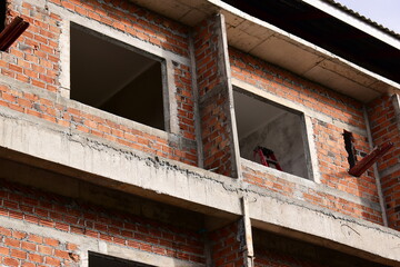 Fototapeta premium exterior view of brick house under construction with concrete structure