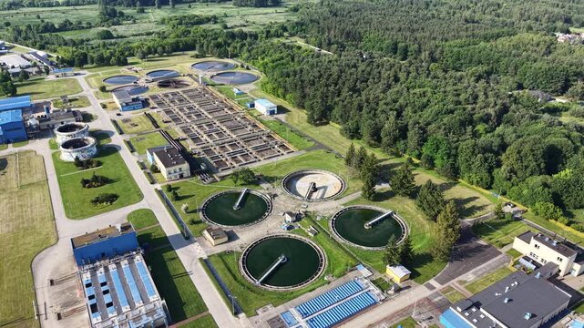 Circular clarifier tanks under warm sunset light
