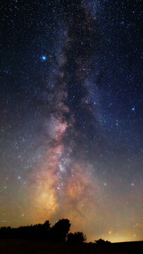 Summer Milky Way stars and landscape scenery silhouettes.