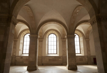 Fototapeta premium Ancient architecture and historical building interior, stone arches and vaulted ceiling with natural light from windows