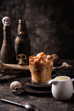 Halloween drink coffee latte with ice in shape of skull
