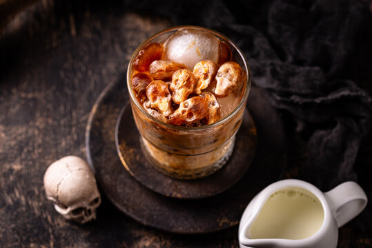 Halloween drink coffee latte with ice in shape of skull