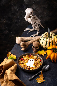 Halloween spooky breakfast with granola and yogurt in shape of ghost
