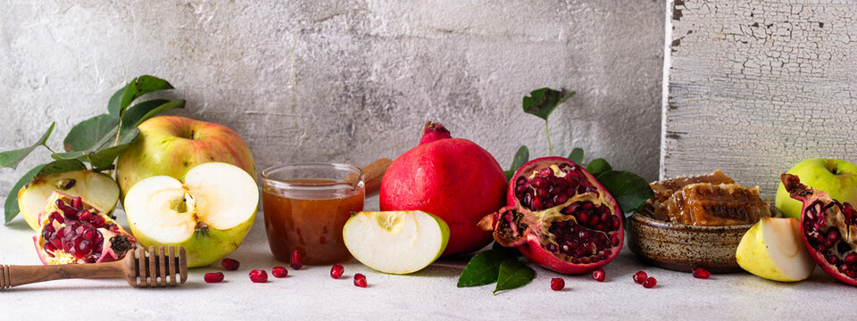 Rosh Hashana Jewish New Year concept with honey apple and pomegranate