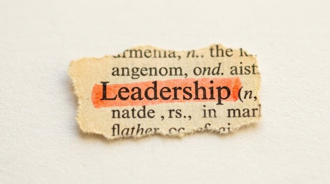 Ripped piece of torn dictionary paper showing the leadership definition.