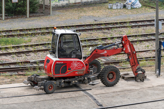 Nancy, France - August 5th 2026 : View on a red mobile walking excavator Euromach R45 on a construction site for railway works with railway lines in the background.