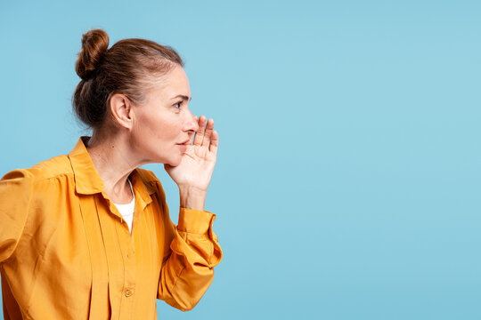 Woman sharing secret information whispering a rumor