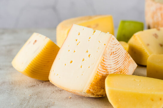 Various kind of craft cheese. Cheese assortment of different types of hard and soft cheeses.