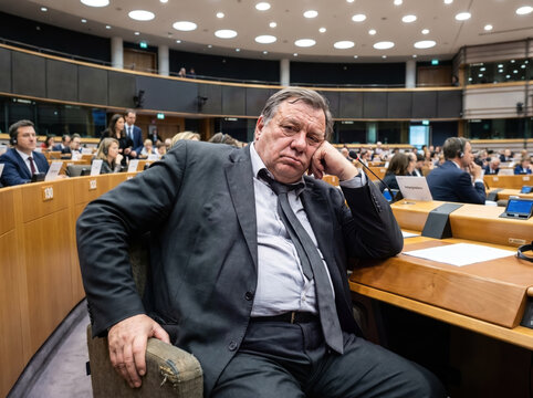Bored businessman or politician sitting in a parliament plenary hall