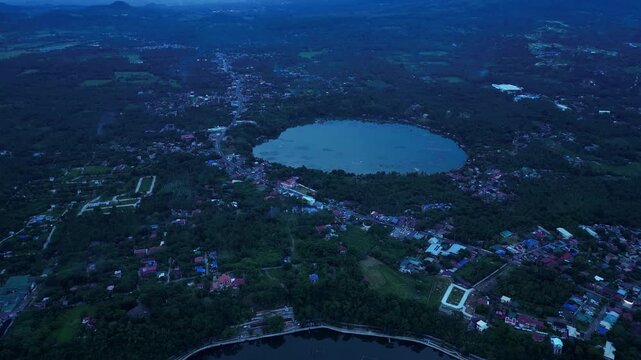 Aerial footage documenting Sampaloc Lake and Bunot Lake in San Pablo City, Laguna, Philippines, featuring freshwater volcanic lakes, urban landscapes, , and Mount San Cristobal during dawn.