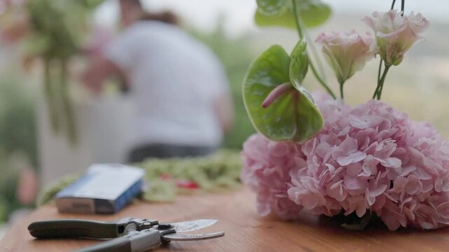 Florist workspace with pink hydrangea and anthurium