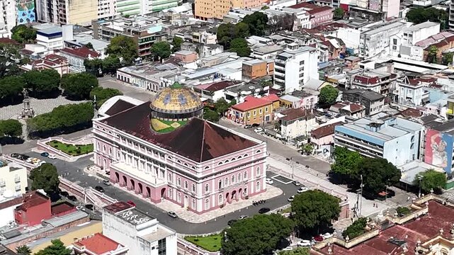 Stunning aerial footage of the facade and colorful dome of the historic Amazon Theatre located in the Manaus city center.