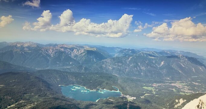 Zugspitze summit panorama with Eibsee and distant Alpine peaks