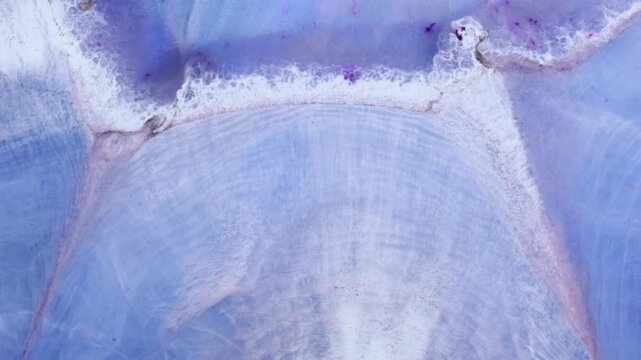 Mixing different colored alcohol inks and epoxy resin in a close-up view