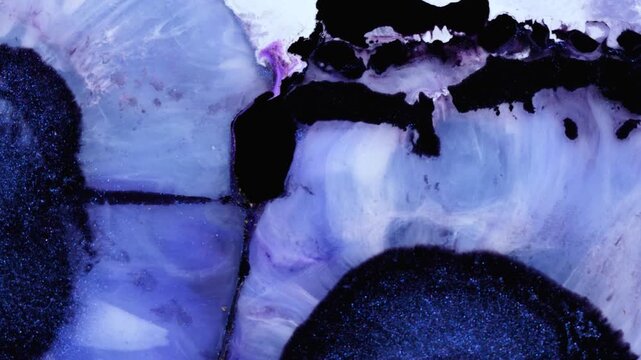 Mixing colored alcohol inks with epoxy resin in close-up view