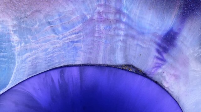 Mixing different colored alcohol inks and epoxy resin in close-up view