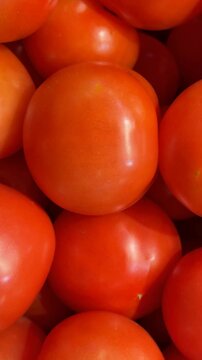 Closeup of ripe red tomatoes showing smooth skins and natural texture as a food background