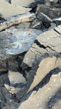 Weathered asphalt and concrete debris create a textured industrial background