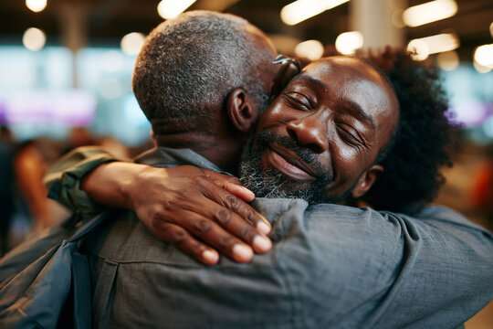 Emotional Reunion Hug Between Two Men at Airport Arrival