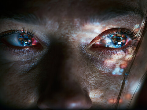 Close Up of Tired Eyes Reflecting Computer Screen at Night