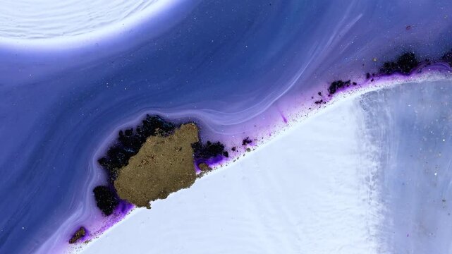 Mixing different colored alcohol inks with epoxy resin on a surface