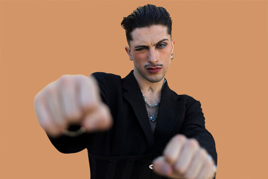 Young man winking with fists extended forward